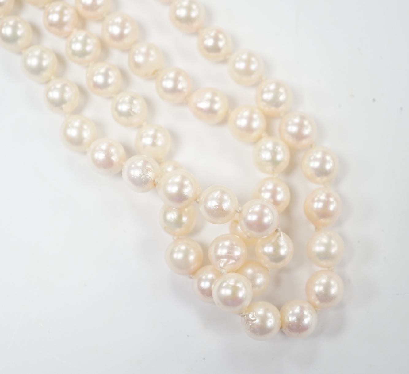 A double strand cultured pearl necklace, with cabochon sapphire and diamond chip cluster set 14k clasp, 44cm. Condition - good